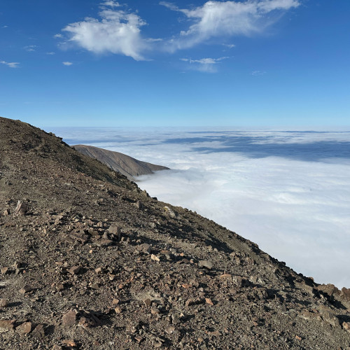 View to the SW showing the escarpment. The sea is under the clouds.