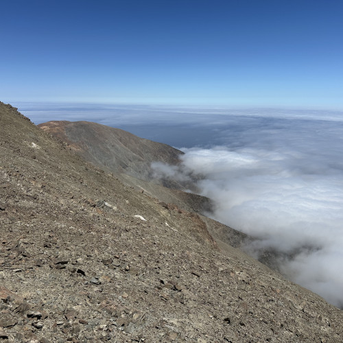 View towards the SW showing the escarpment slopes. Beneath the clouds lies the sea.